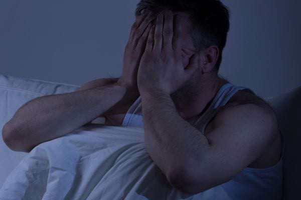 Homme fatigué se frottant les yeux
